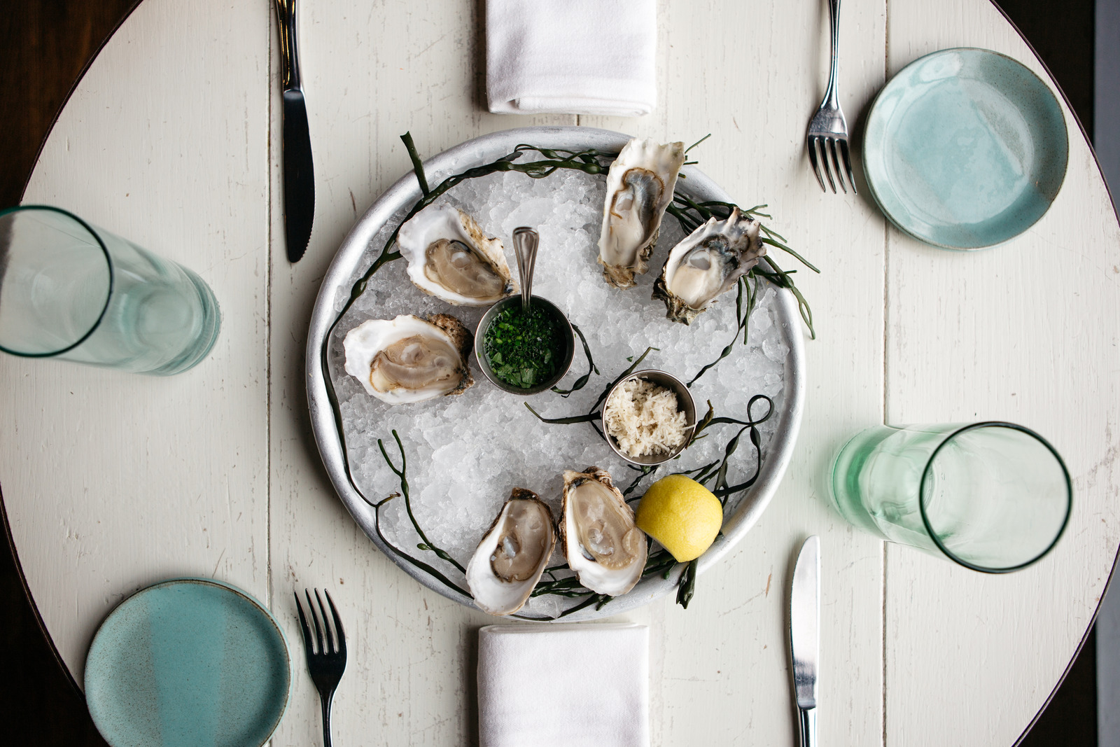 An oyster platter on a set dining table