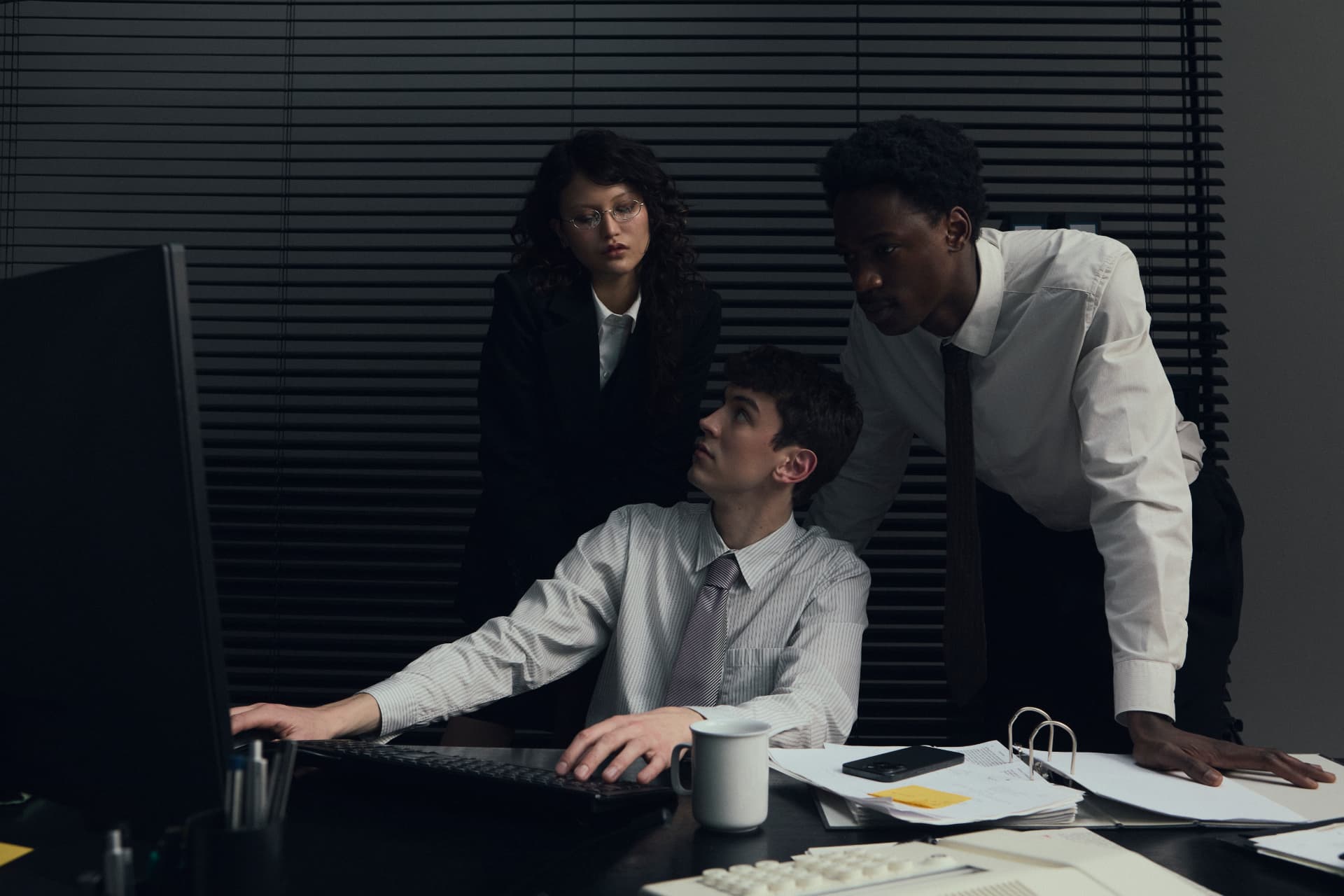 The Premiere Concierge team gathered around a desk mid-task